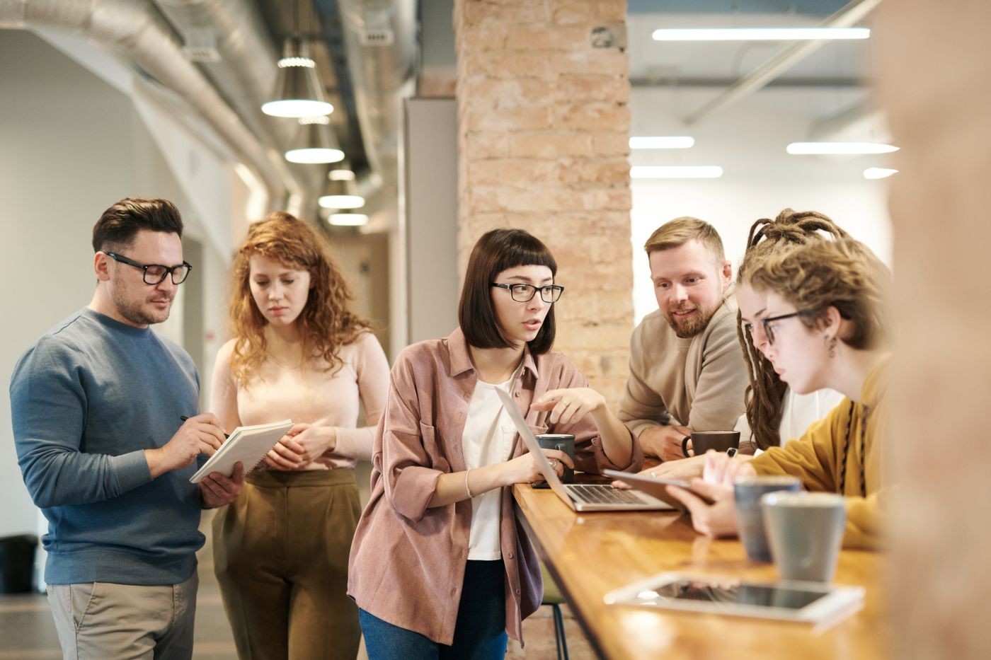 Students sketching a business idea at a whiteboard